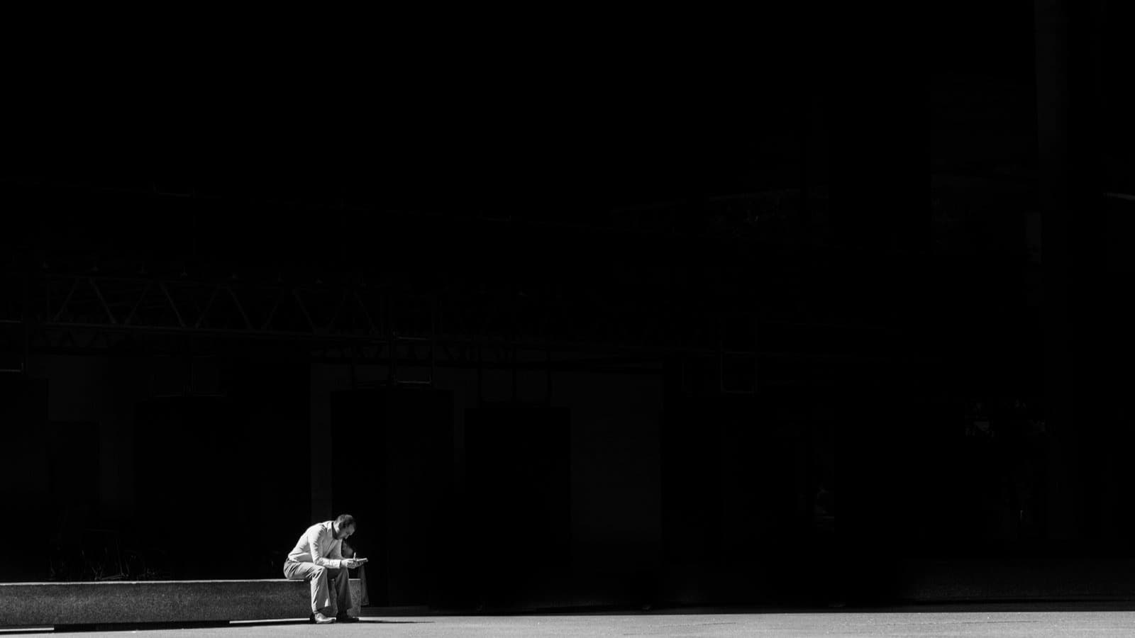 A person standing between an empty room and a dim emotional weather chart